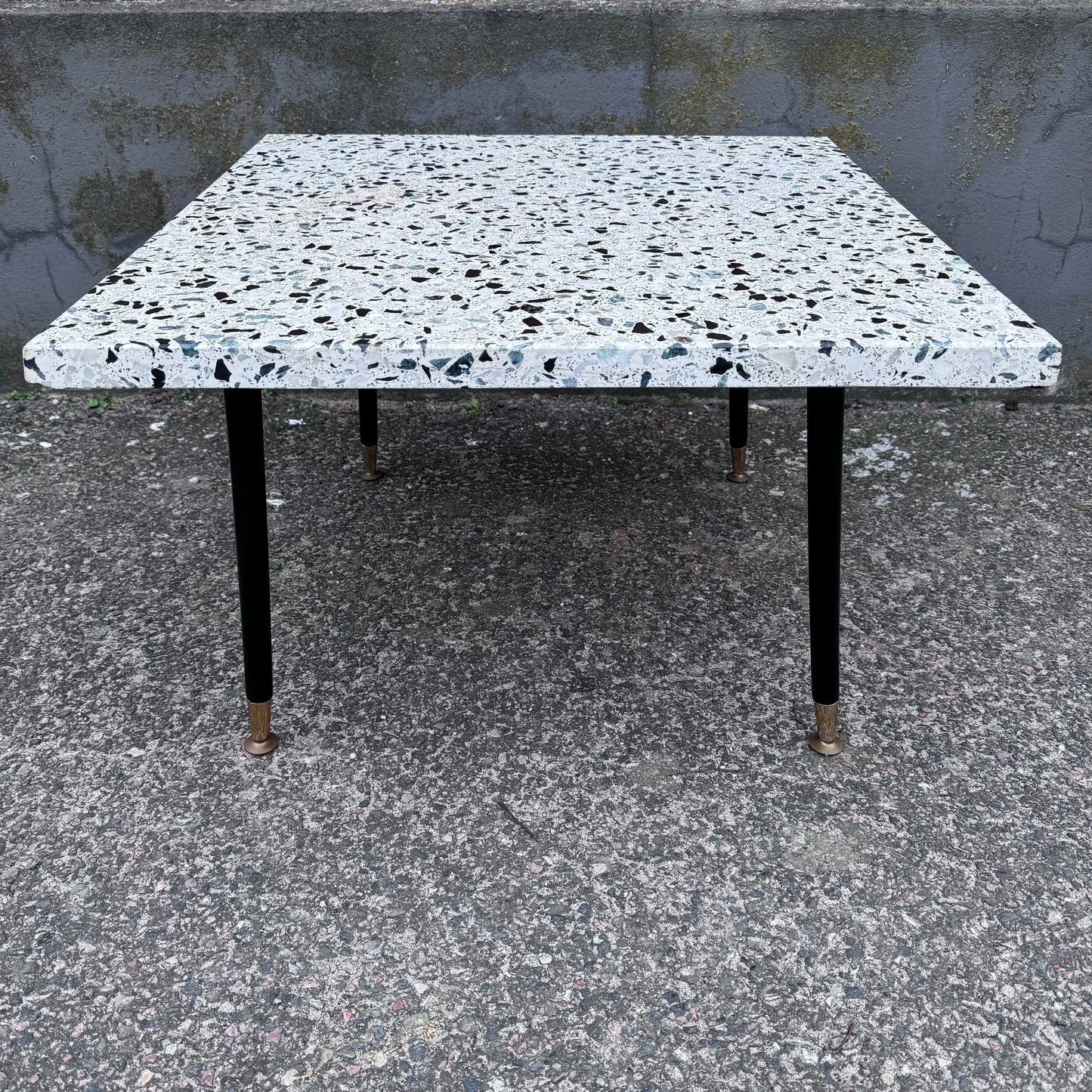 Coffee table in terrazzo with brass details