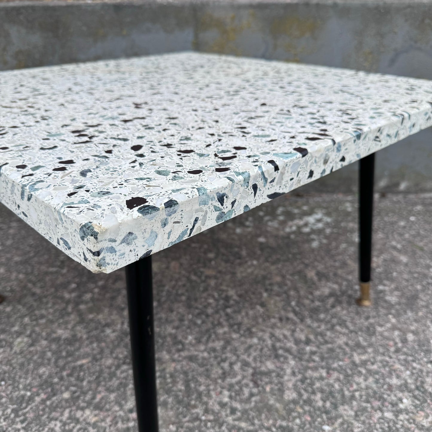 Coffee table in terrazzo with brass details