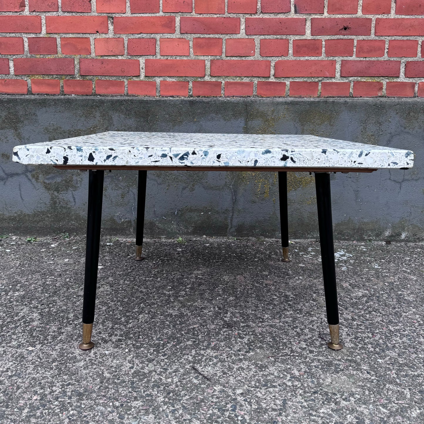 Coffee table in terrazzo with brass details