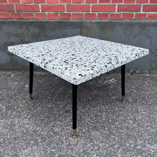 Coffee table in terrazzo with brass details